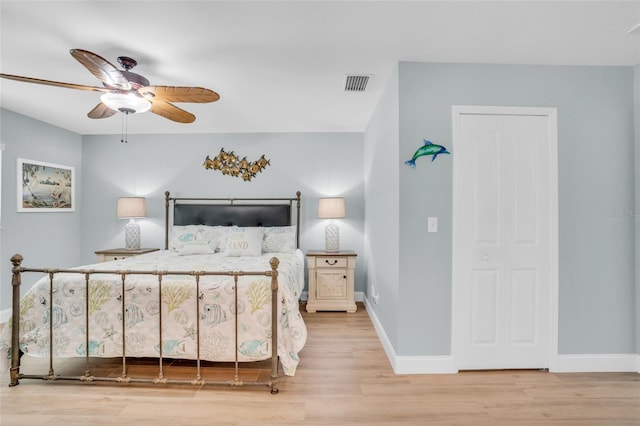 bedroom with ceiling fan and light hardwood / wood-style floors