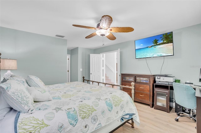 bedroom with light hardwood / wood-style flooring and ceiling fan