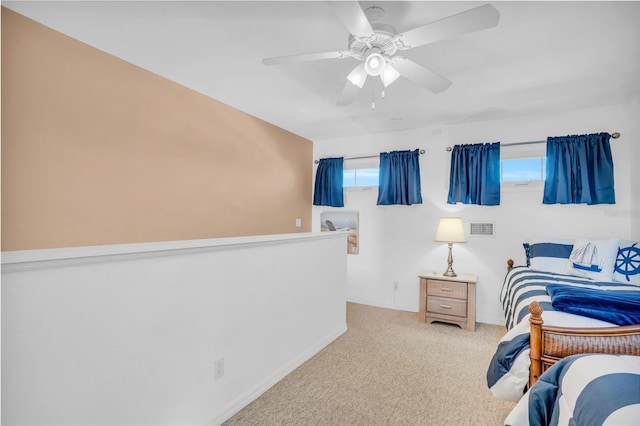 bedroom with ceiling fan and light carpet