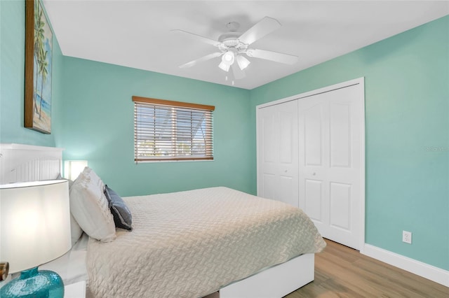 bedroom with ceiling fan, a closet, and hardwood / wood-style flooring