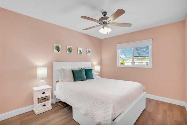 bedroom with hardwood / wood-style flooring and ceiling fan