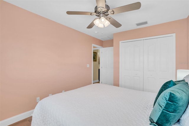 bedroom featuring ceiling fan, a closet, and wood-type flooring