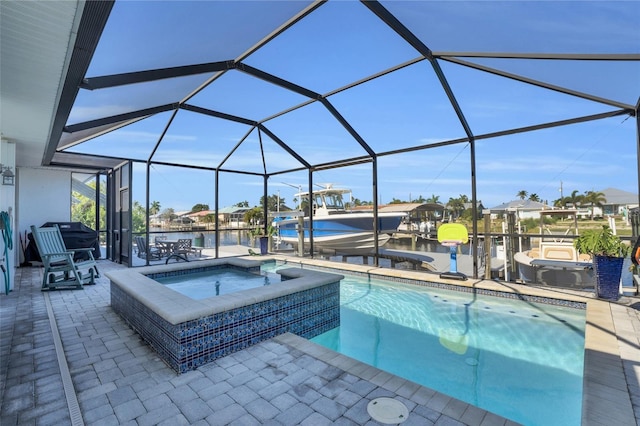 view of swimming pool featuring an in ground hot tub, a water view, a patio area, and a lanai