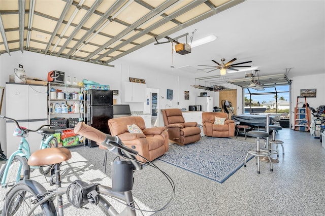 garage with ceiling fan, black refrigerator, white fridge, and a garage door opener