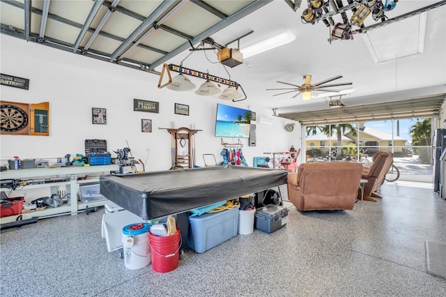 garage featuring ceiling fan and a garage door opener