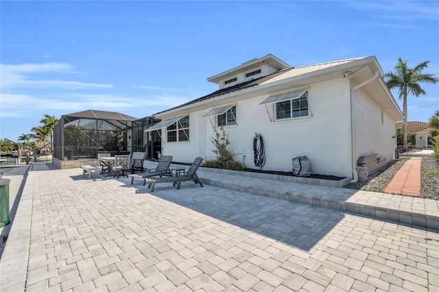 back of house featuring a patio area and a lanai