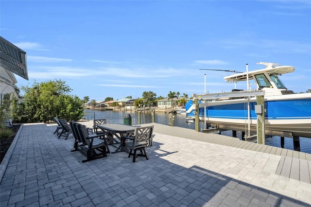 view of patio / terrace featuring a water view and a dock