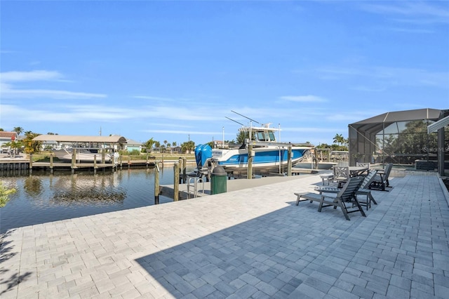 dock area with glass enclosure and a water view