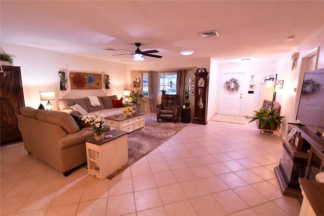 tiled living room featuring ceiling fan