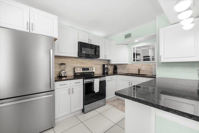 kitchen featuring white cabinets, sink, decorative backsplash, appliances with stainless steel finishes, and light tile patterned flooring