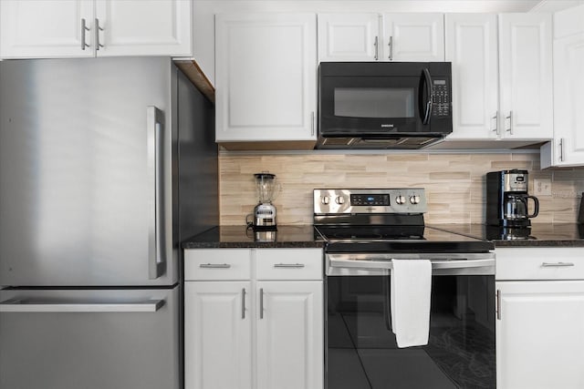 kitchen with white cabinets, appliances with stainless steel finishes, backsplash, and dark stone counters