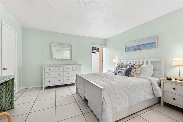 bedroom featuring a textured ceiling and light tile patterned flooring