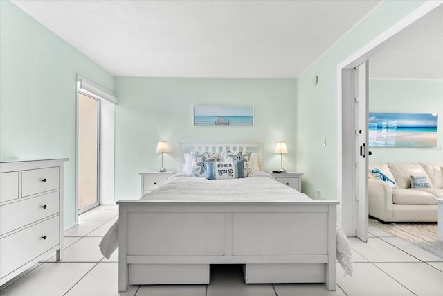 tiled bedroom with a textured ceiling and access to outside