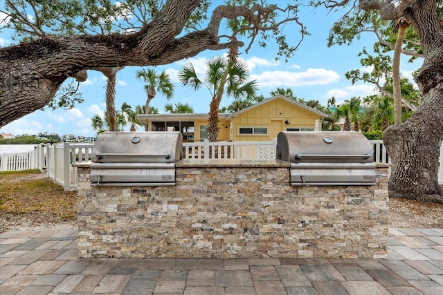 view of patio featuring a grill and an outdoor kitchen