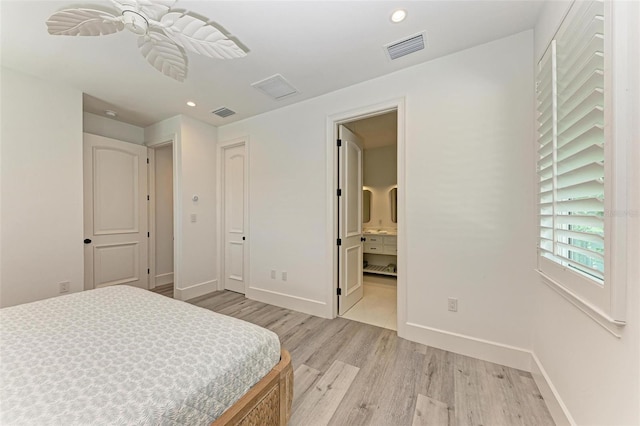 bedroom with ensuite bathroom and light hardwood / wood-style flooring