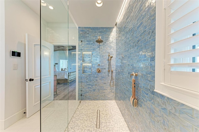 bathroom featuring tiled shower and tile patterned floors