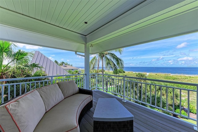 balcony with a water view and an outdoor hangout area