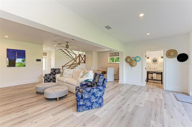 living room with light hardwood / wood-style floors and ceiling fan