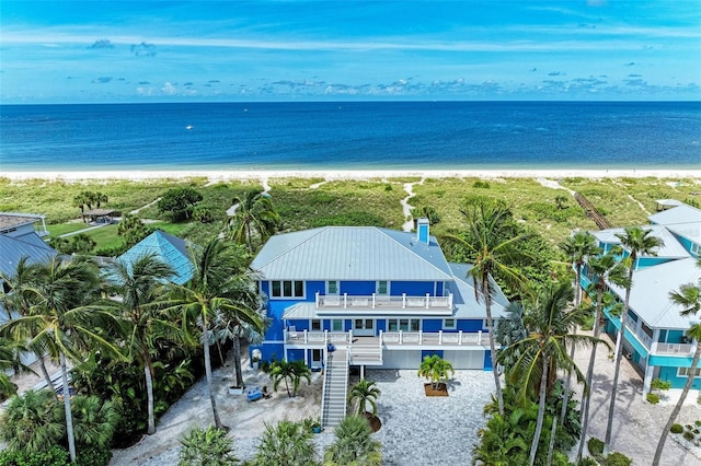 bird's eye view featuring a water view and a beach view