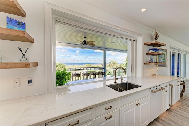 506 S Casey Key Rd, Nokomis, FL 34275 - kitchen featuring open shelves, a sink, white dishwasher, white cabinetry, and light stone counters