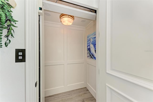 506 S Casey Key Rd, Nokomis, FL 34275 - elevator featuring a decorative wall and wood finished floors