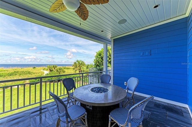 506 S Casey Key Rd, Nokomis, FL 34275 - deck with outdoor dining area, ceiling fan, a water view, and a yard