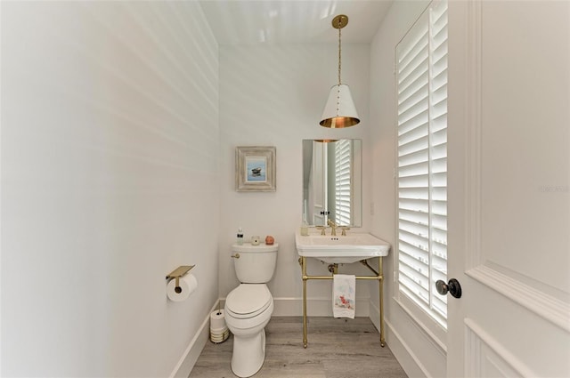506 S Casey Key Rd, Nokomis, FL 34275 - half bath featuring wood finished floors, toilet, and baseboards