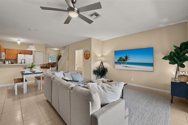 tiled living room featuring ceiling fan