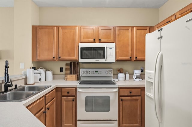 kitchen featuring sink and white appliances