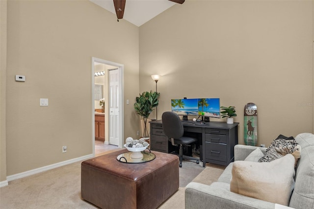 home office with ceiling fan, high vaulted ceiling, and light carpet