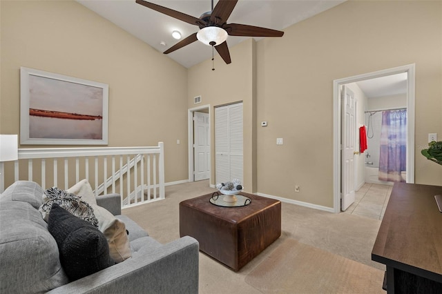 living room with light carpet, ceiling fan, and high vaulted ceiling