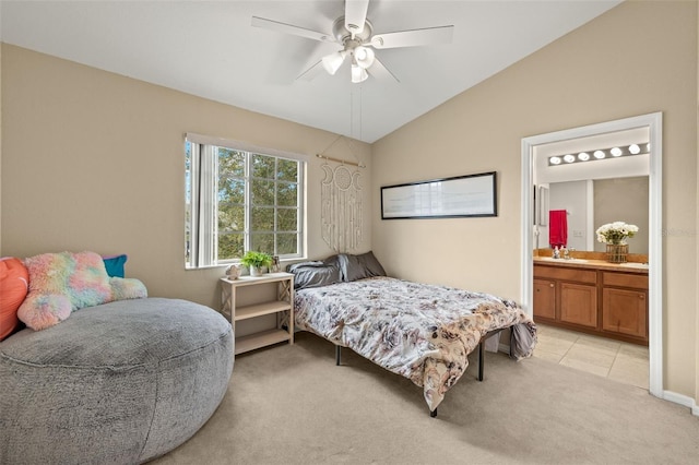 carpeted bedroom featuring ceiling fan, sink, ensuite bathroom, and lofted ceiling