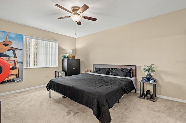 bedroom with ceiling fan and light carpet