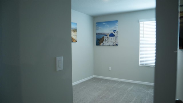 unfurnished room with light colored carpet