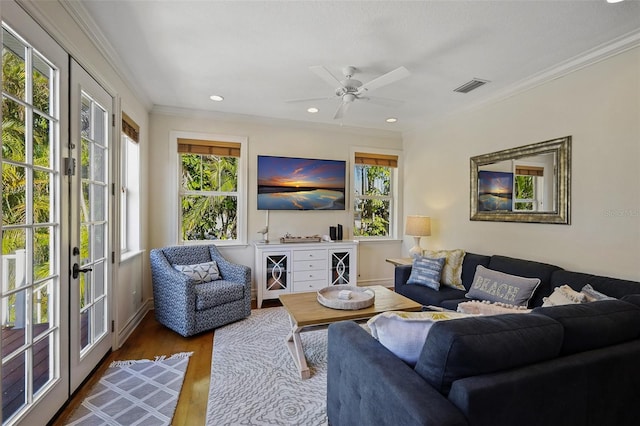 living room featuring a wealth of natural light, french doors, and hardwood / wood-style floors