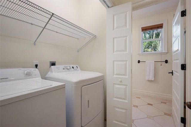 clothes washing area with separate washer and dryer