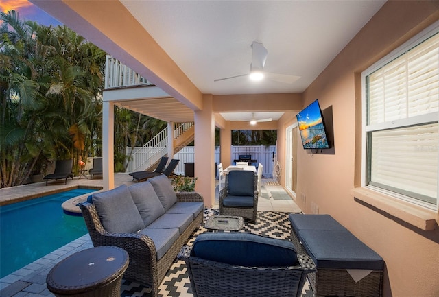 patio terrace at dusk featuring ceiling fan, a fenced in pool, and an outdoor hangout area