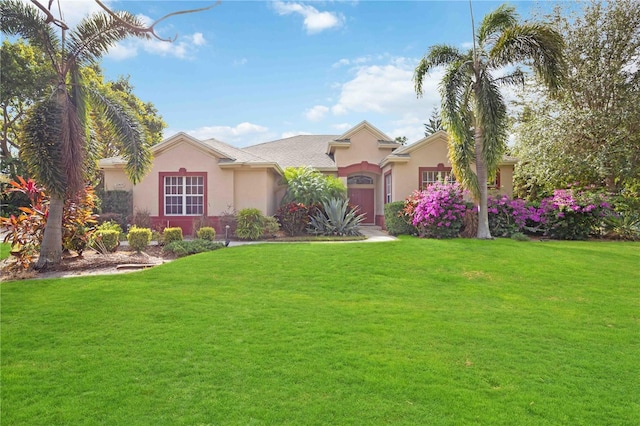 ranch-style home featuring a front lawn