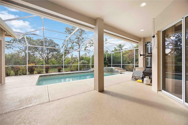 view of swimming pool featuring glass enclosure and a patio