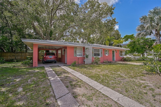 ranch-style home with a front yard and a carport