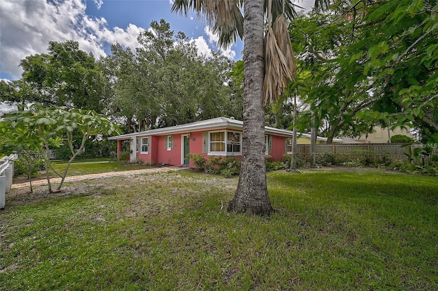 ranch-style home with a front lawn