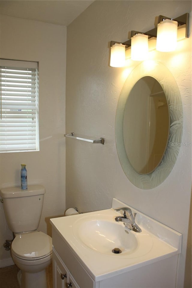 bathroom with toilet and vanity