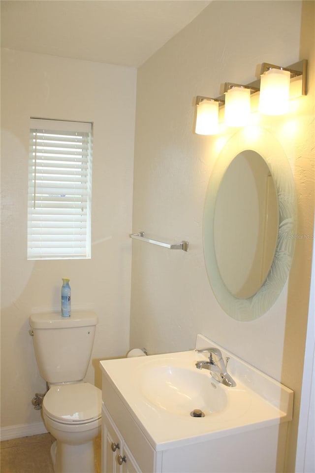 bathroom featuring tile patterned flooring, vanity, and toilet