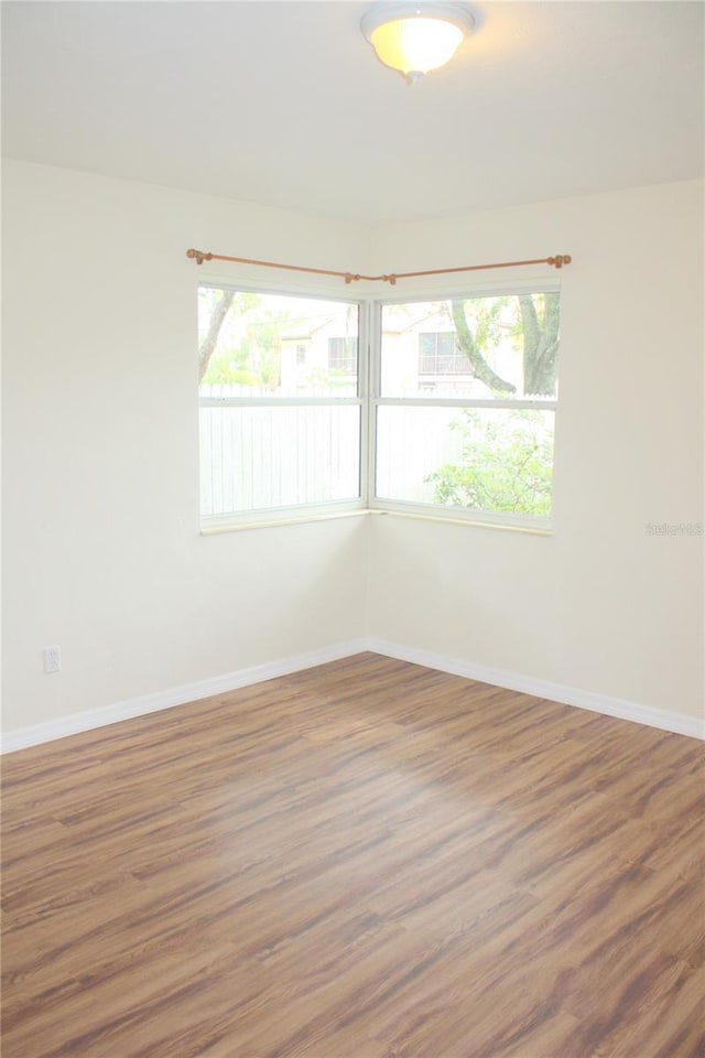 unfurnished room with dark wood-type flooring