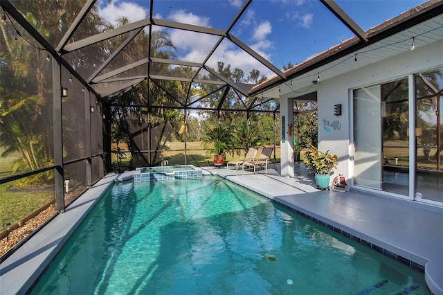 view of pool featuring glass enclosure and a patio area