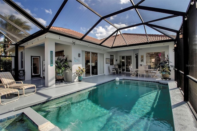 view of swimming pool featuring a patio and a lanai