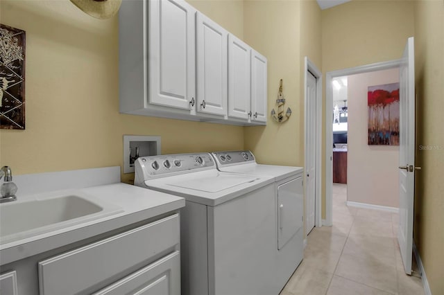 laundry room featuring sink, cabinets, independent washer and dryer, and light tile patterned floors