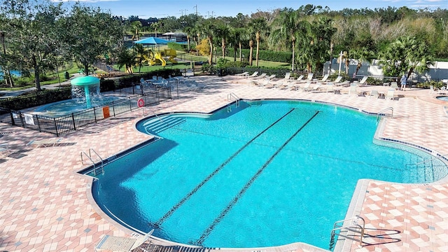 view of pool featuring a patio and a water slide