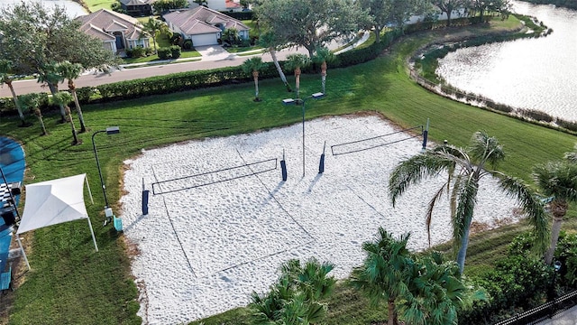 view of property's community with a yard and volleyball court