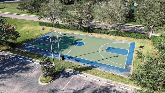 view of sport court featuring a lawn